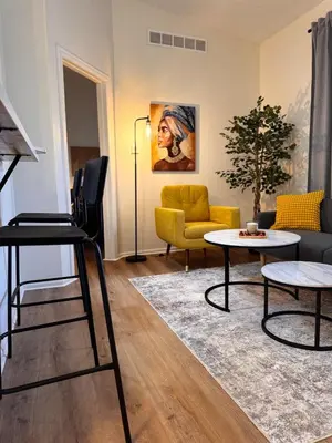 a living room with a couch and a table at Beautifully Renovated OneBedroom Apt with Two Beds in Littleton