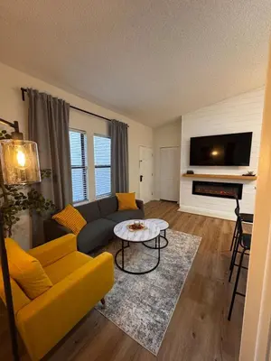a living room with a couch and a table at Beautifully Renovated OneBedroom Apt with Two Beds in Littleton