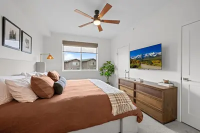 a bedroom with a bed and a ceiling fan at 301 W Meadow Mile #3 in Fraser
