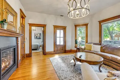 a living room with a couch and a fireplace at Downtown Walkability - The Purple House in Berthoud