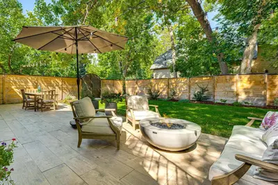 a patio with a fire pit and an umbrella at Downtown Walkability - The Purple House in Berthoud