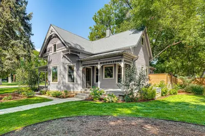a gray house with a yard with grass at Downtown Walkability - The Purple House in Berthoud