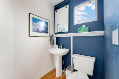 a bathroom with a white toilet and a sink at New Denver Escape. 3 bedroom. Near everything. in Denver