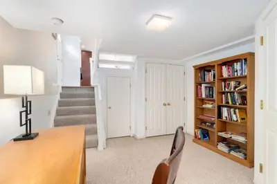 a home office with a desk and bookshelves at New Denver Escape. 3 bedroom. Near everything. in Denver