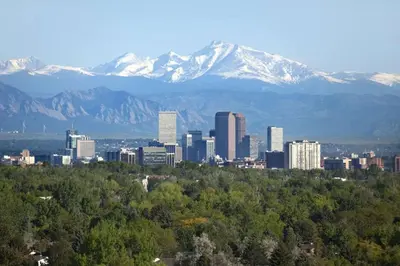 a city with mountains in the background with trees and buildings at New Denver Escape. 3 bedroom. Near everything. in Denver