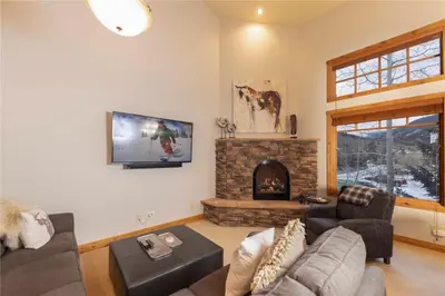 a living room with a couch and a fireplace at 24 Autumn Brook townhouse in Dillon