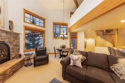 a living room with a couch and a fireplace at 24 Autumn Brook townhouse in Dillon
