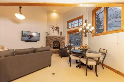 a living room with a couch and a table and a fireplace at 24 Autumn Brook townhouse in Dillon