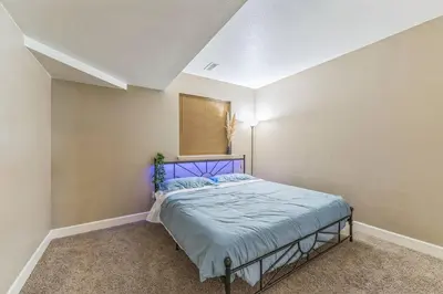 a bedroom with a blue bed in a room at Free Night! Movies, Games & BBQ|25 mins>DT Denver in Brighton