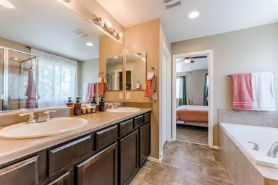 a bathroom with two sinks and a tub and a bed at Free Night! Movies, Games & BBQ|25 mins>DT Denver in Brighton