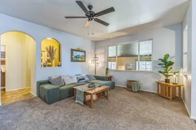 a living room with a couch and a ceiling fan at Free Night! Movies, Games & BBQ|25 mins>DT Denver in Brighton