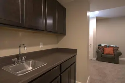 a kitchen with a sink and a couch in a room at Free Night! Movies, Games & BBQ|25 mins>DT Denver in Brighton