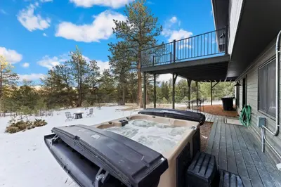 a hot tub on the patio of a house at New The Pine Getaway Lots of Room Hot Tub Views in Pine