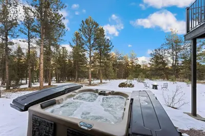 a jacuzzi tub in a snow covered yard at New The Pine Getaway Lots of Room Hot Tub Views in Pine