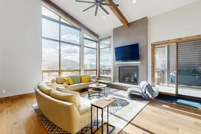 a living room with a couch and a fireplace at Lakota Northwoods Luxury Villa 308 in Winter Park