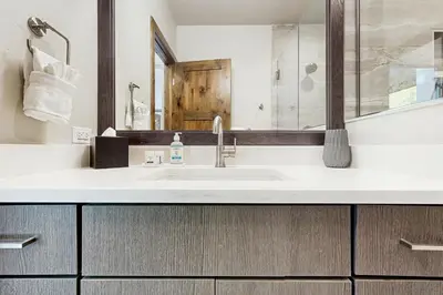 a bathroom with a sink and a mirror at Lakota Northwoods Luxury Villa 308 in Winter Park