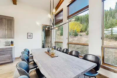 a dining room with a large table and chairs at Lakota Northwoods Luxury Villa 308 in Winter Park