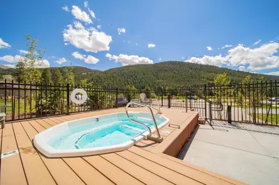 a hot tub on the deck of a house at 1 bedroom apartment free electric charger Keystone in Keystone