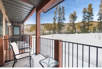 a porch with two chairs and a snow covered field at 1 bedroom apartment free electric charger Keystone in Keystone