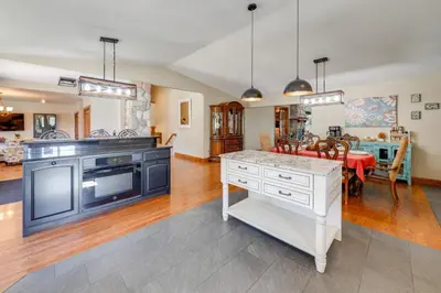 a kitchen with a stove and a table in a room at Loveland Peaks Retreat Family Home 3 Mi to Dtwn! in Loveland