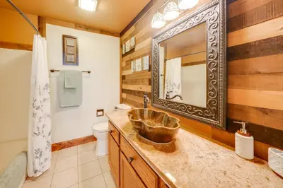 a bathroom with a sink and a mirror at Loveland Peaks Retreat Family Home 3 Mi to Dtwn! in Loveland