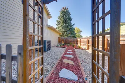 a garden with a fence next to a house at Loveland Peaks Retreat Family Home 3 Mi to Dtwn! in Loveland