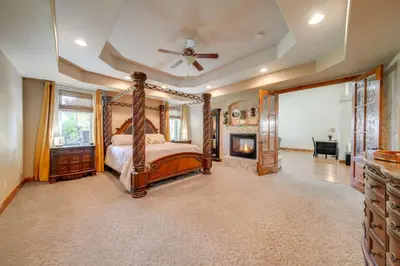 a bedroom with a canopy bed and a fireplace at Loveland Peaks Retreat Family Home 3 Mi to Dtwn! in Loveland