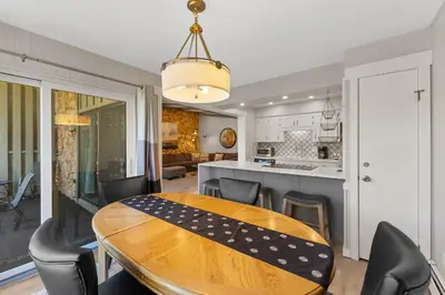 a kitchen and dining room with a wooden table and chairs at Lake Cliffe 305 Building A in Dillon