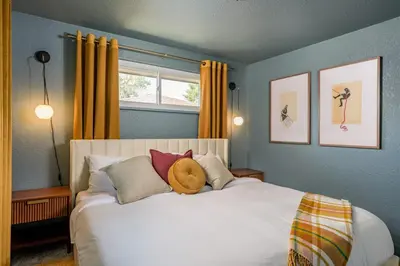 a bedroom with a white bed with a teddy bear on it at Sleeps 16 Hot Tub Arcade Movie Theater Pool Table in Westminster