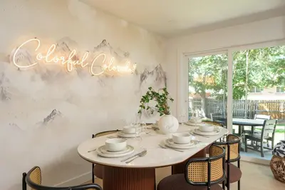 a dining room with a table with a sign that reads cocktail delight at Sleeps 16 Hot Tub Arcade Movie Theater Pool Table in Westminster