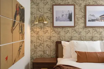 a bedroom with a bed and a wall with wallpaper at Sleeps 16 Hot Tub Arcade Movie Theater Pool Table in Westminster