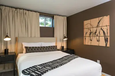 a bedroom with a large white bed and a window at Sleeps 16 Hot Tub Arcade Movie Theater Pool Table in Westminster