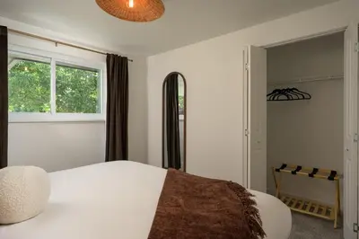 a bedroom with a white bed and a window at Sleeps 16 Hot Tub Arcade Movie Theater Pool Table in Westminster