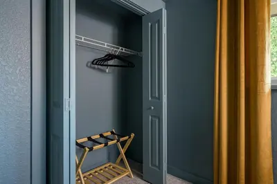 a room with a door and a chair and a closet at Sleeps 16 Hot Tub Arcade Movie Theater Pool Table in Westminster