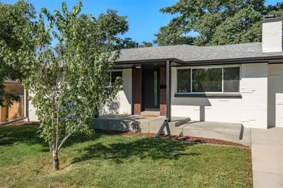 a house with a tree in the front yard at Sleeps 16 Hot Tub Arcade Movie Theater Pool Table in Westminster