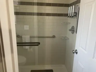 a bathroom with a shower with a glass door at Cabins on Main Longmont in Longmont