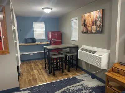 a room with a table and stools and a table with a heater at Cabins on Main Longmont in Longmont