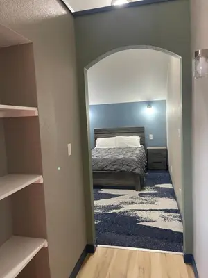 a bedroom with a bed and a large mirror at Cabins on Main Longmont in Longmont