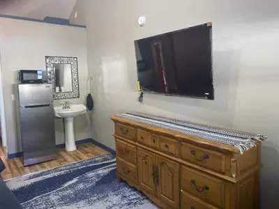 a bathroom with a large tv on the wall at Cabins on Main Longmont in Longmont