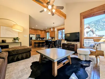 a living room with a couch and a table at Settlers Creek 6529 by SummitCove Lodging in Keystone