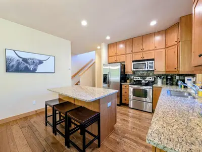 a large kitchen with wooden cabinets and a counter top at Settlers Creek 6529 by SummitCove Lodging in Keystone
