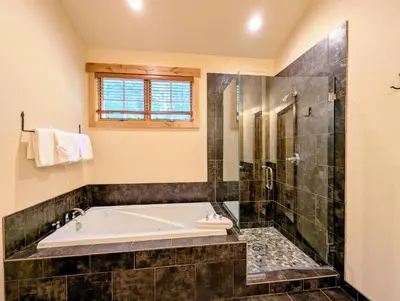 a bathroom with a tub and a glass shower at Settlers Creek 6529 by SummitCove Lodging in Keystone