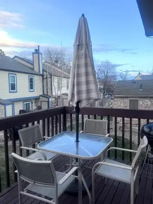 a table and chairs and an umbrella on a deck at Cozy Room with Private Entrance and Patio near Denver in Westminster