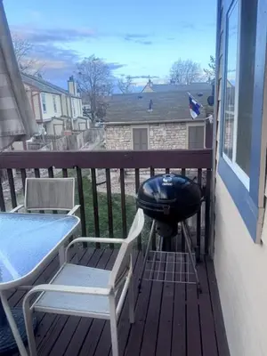 a grill on a balcony with two chairs and a table at Cozy Room with Private Entrance and Patio near Denver in Westminster