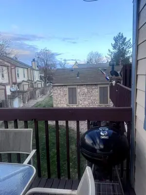 a view of a balcony with a motorcycle on a porch at Cozy Room with Private Entrance and Patio near Denver in Westminster