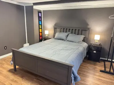 a bedroom with a large bed with two night stands at Cozy Room with Private Entrance and Patio near Denver in Westminster