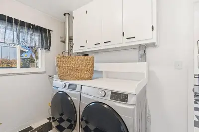 a laundry room with a washer and dryer at Moody Modern Getaway Walk to CSU and City Park in Fort Collins
