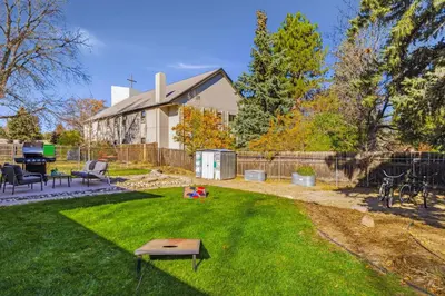 a yard with a house with a fence at Moody Modern Getaway Walk to CSU and City Park in Fort Collins