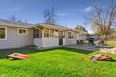 a house with a yard with a table and chairs at Moody Modern Getaway Walk to CSU and City Park in Fort Collins