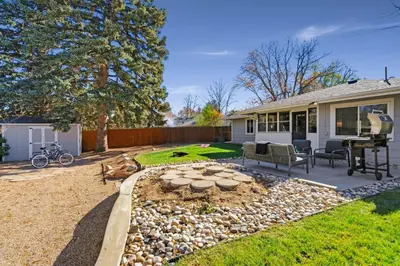 a backyard with a fire pit and a house at Moody Modern Getaway Walk to CSU and City Park in Fort Collins